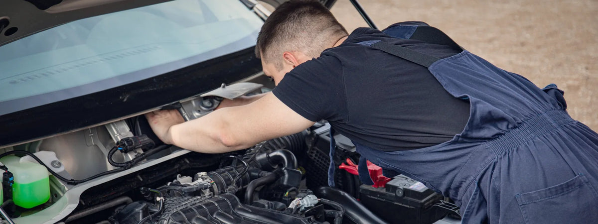 Mechanic working on a car engine